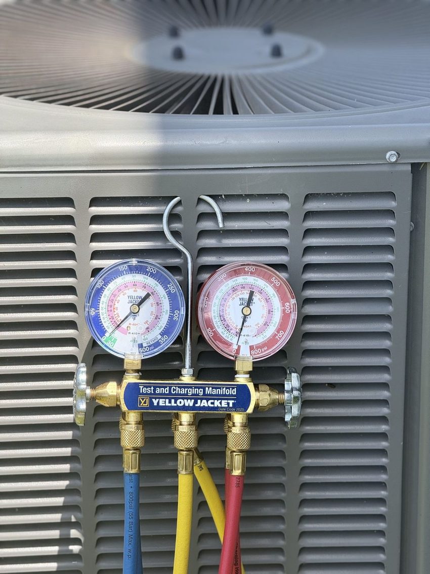 HVAC refrigerant pressure gauges on a test and charging manifold
